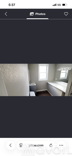 A room with a window and a bathtub.