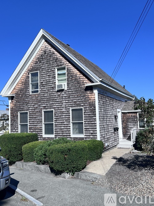 A house with a brick facade and a pitched roof.