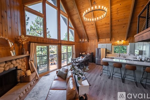 A modern living room with a fireplace and a bar area.