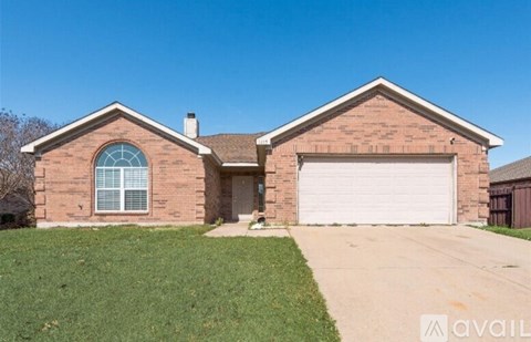 A brick house with a garage door and a window.