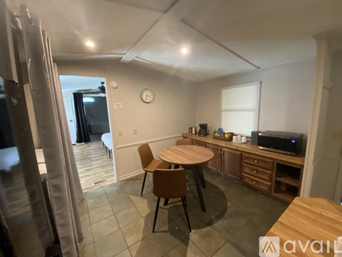 A kitchen with a table and chairs in the middle of the room.