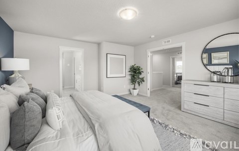 A bedroom with a large bed and a mirror on the wall.