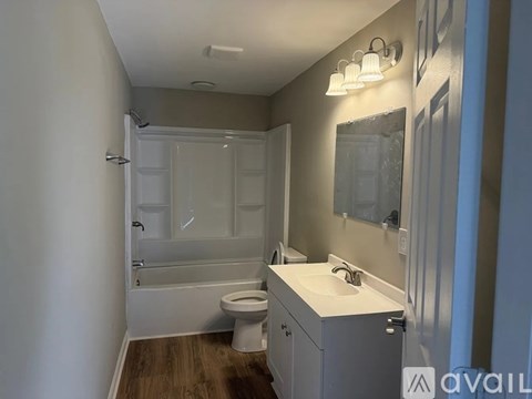 A bathroom with a toilet, sink, and bathtub.