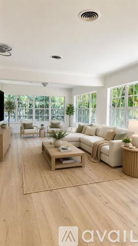 A modern living room with a large sofa set and a coffee table.