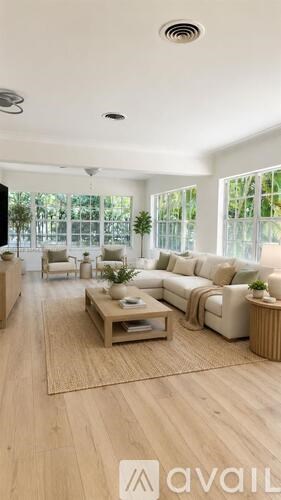A modern living room with a large sofa set and a coffee table.