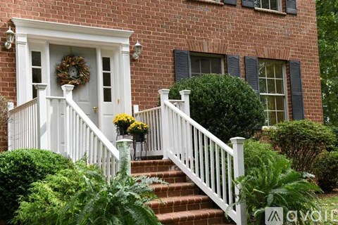 A house with a white door and a wreath on it.