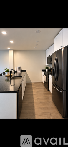 A modern kitchen with a refrigerator on the right side.