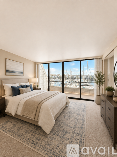 A bedroom with a large bed and a view of the water.
