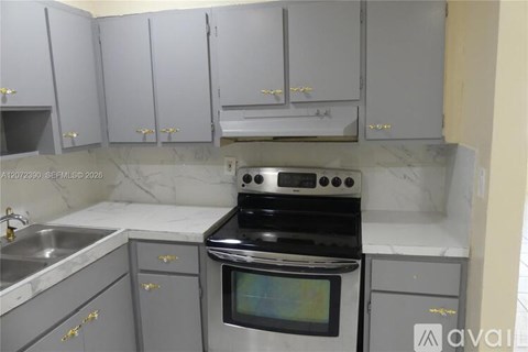 A kitchen with a stove and cabinets.
