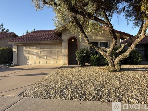 A house with a tree in front of it.