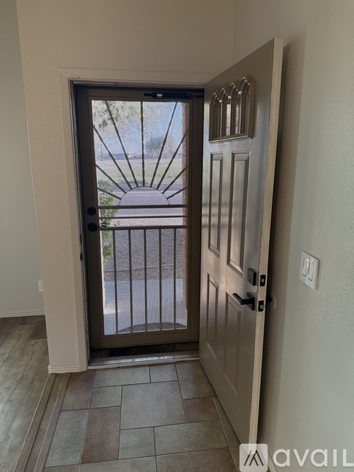 A glass door with a wooden frame is open.
