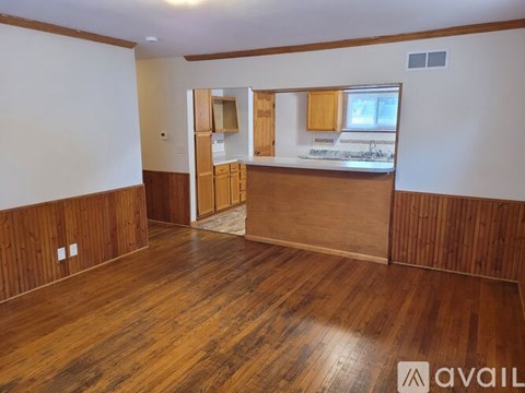 A room with wooden flooring and a ceiling fan.