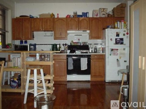 A kitchen with wooden cabinets and a white fridge.