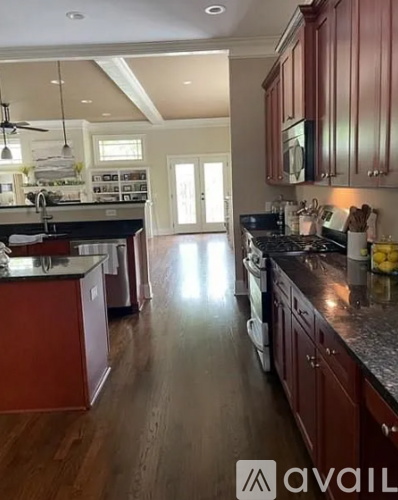 A kitchen with wooden cabinets and a black countertop.