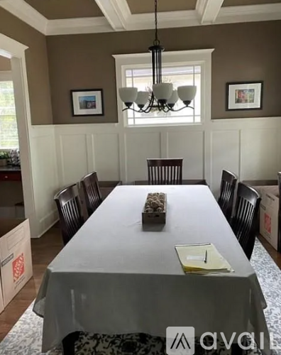 A dining room with a table set for four.