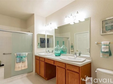 A bathroom with a sink, mirror, and towel.
