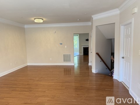 A room with wooden floors and white walls.
