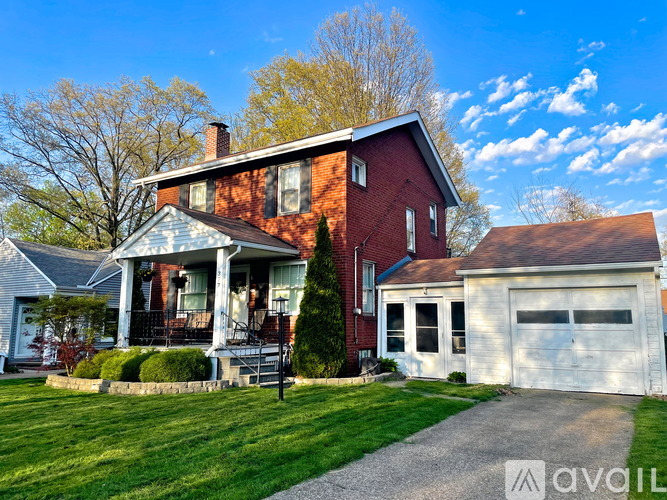 A red brick house with a white garage door.