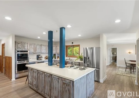 A modern kitchen with a large island and wooden cabinets.