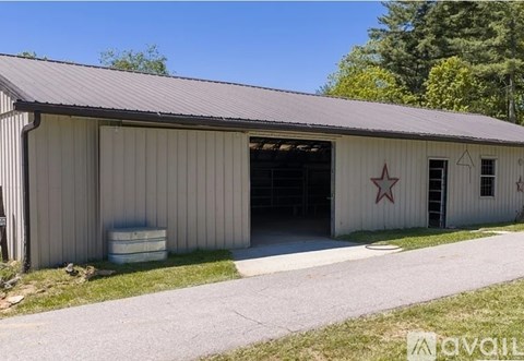 A large metal building with a red star on the side.