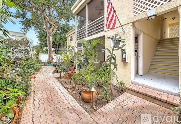 A small garden with a flag on a balcony.