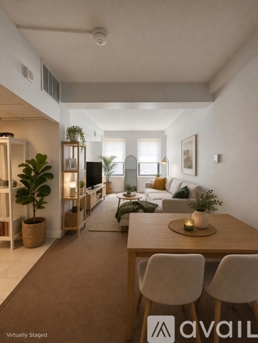 A modern living room with a dining table and chairs.