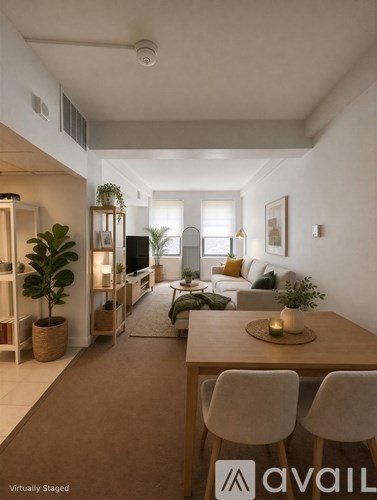 A modern living room with a dining table and chairs.