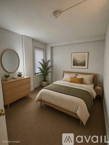 A bedroom with a bed, dresser, and mirror.