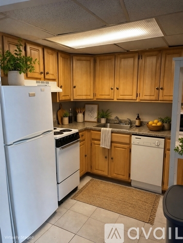 A kitchen with wooden cabinets and white appliances.