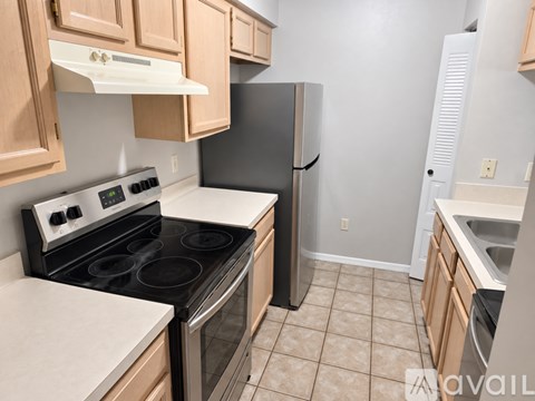 A kitchen with a stove, oven, and refrigerator.