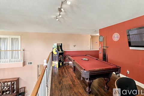 A pool table in a room with a balcony.