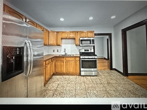 A kitchen with wooden cabinets and stainless steel appliances.
