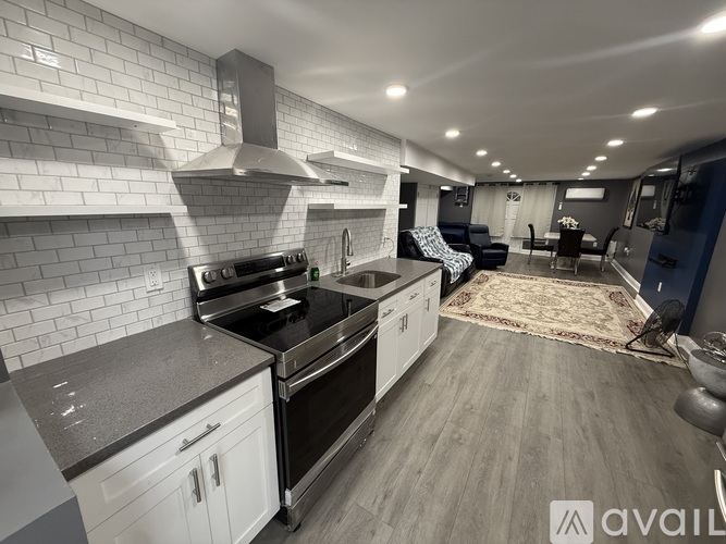 A modern kitchen with stainless steel appliances and white cabinets.