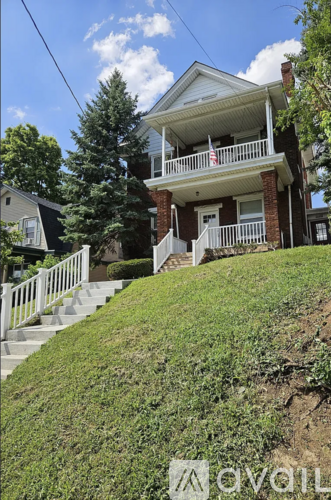 A house with a flag on the balcony is for sale.
