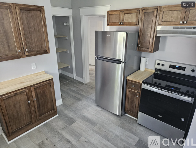 A kitchen with a stainless steel refrigerator and oven.