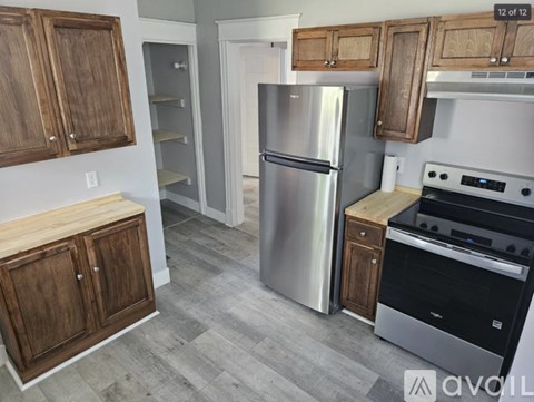 A kitchen with a stainless steel refrigerator and oven.
