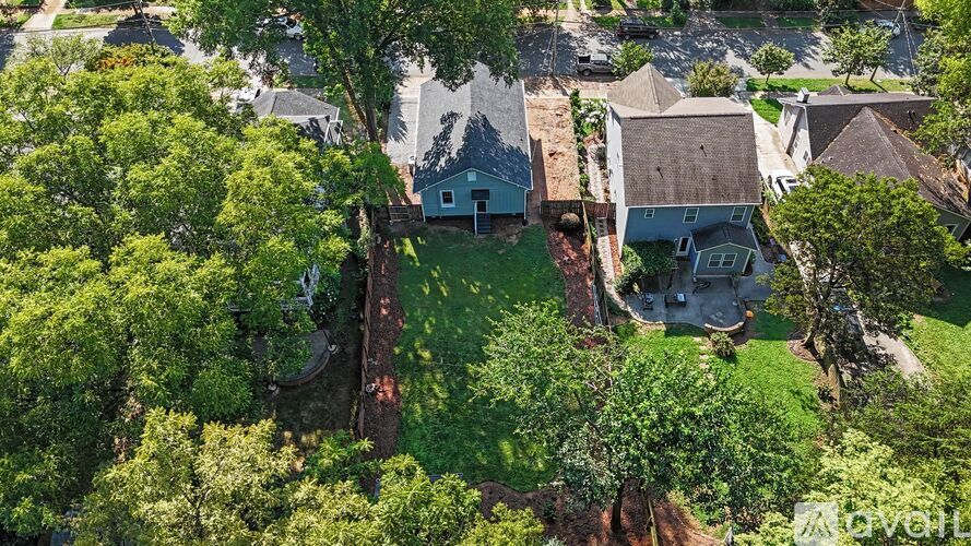 A bird's eye view of a residential area with houses and trees.