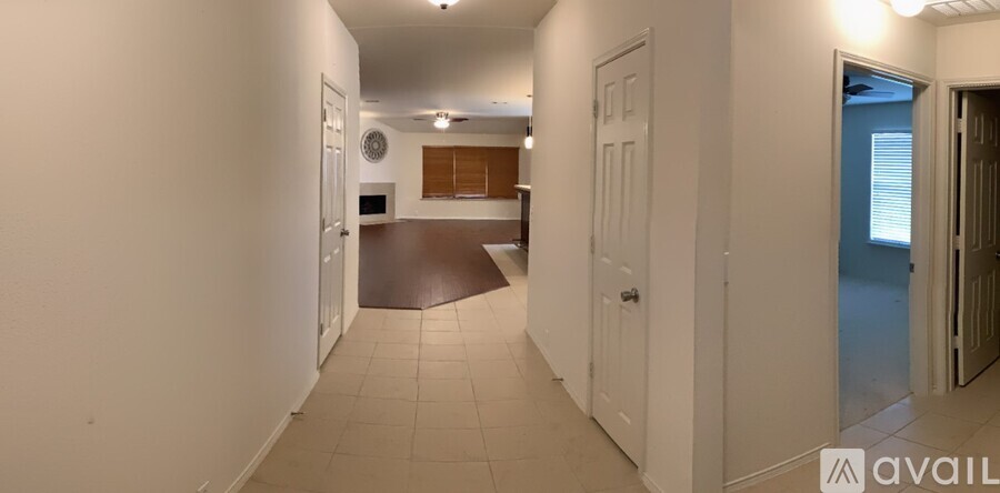 A long hallway with doors on both sides.