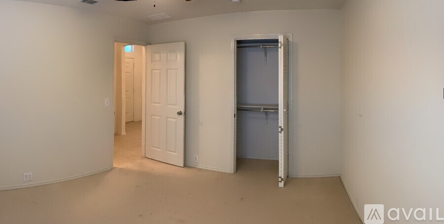 A room with a white door and a window with a white frame.