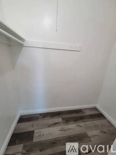 A room with a wooden floor and white walls.
