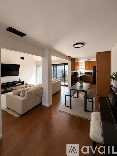 A living room with a white couch and a black coffee table.