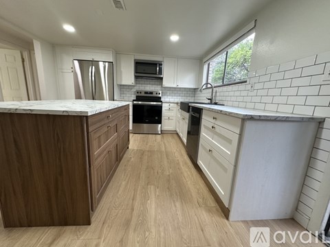 A kitchen with wooden cabinets and a white countertop.