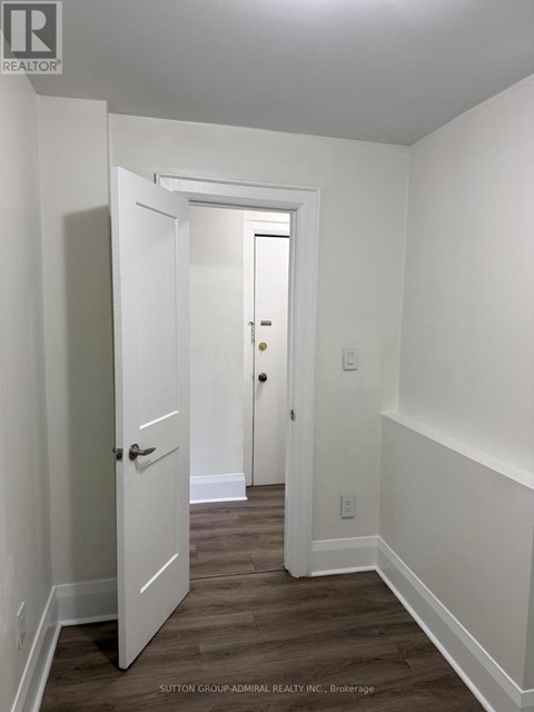 A hallway with a door on the left and a door on the right.
