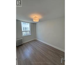 A room with a window and a radiator on the floor.