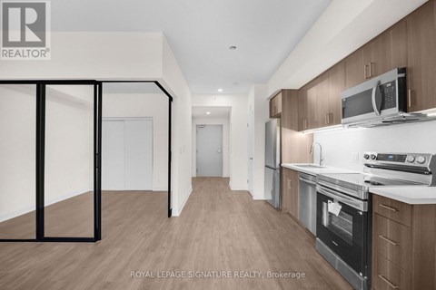 A kitchen with wooden cabinets and a white countertop.