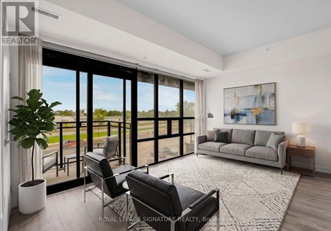 A living room with a large window and a view of the outdoors.