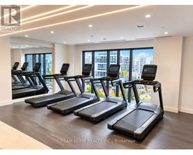 A gym with treadmills and a view of the city.