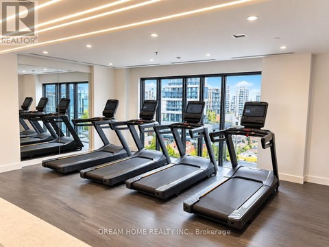 A gym with treadmills and a view of the city.