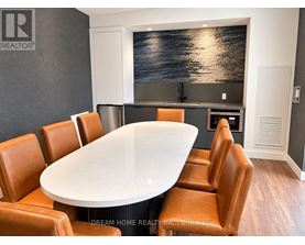 A conference room with a large table and chairs.