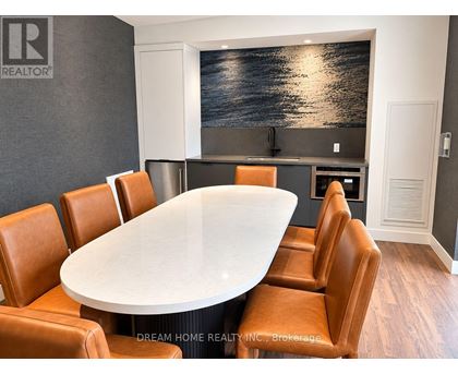 A conference room with a large table and chairs.